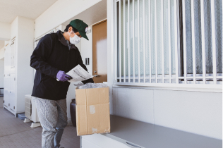 Man looking at documents from an open cardboard box